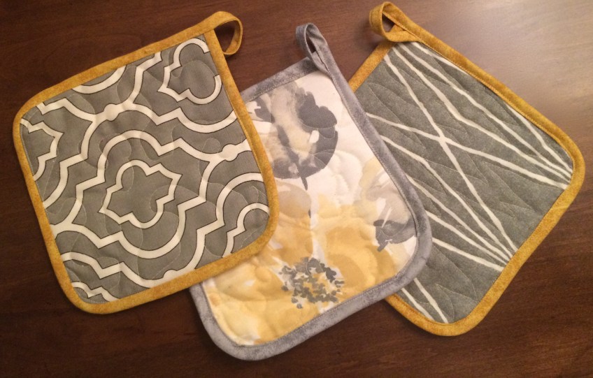 Gray and yellow potholders